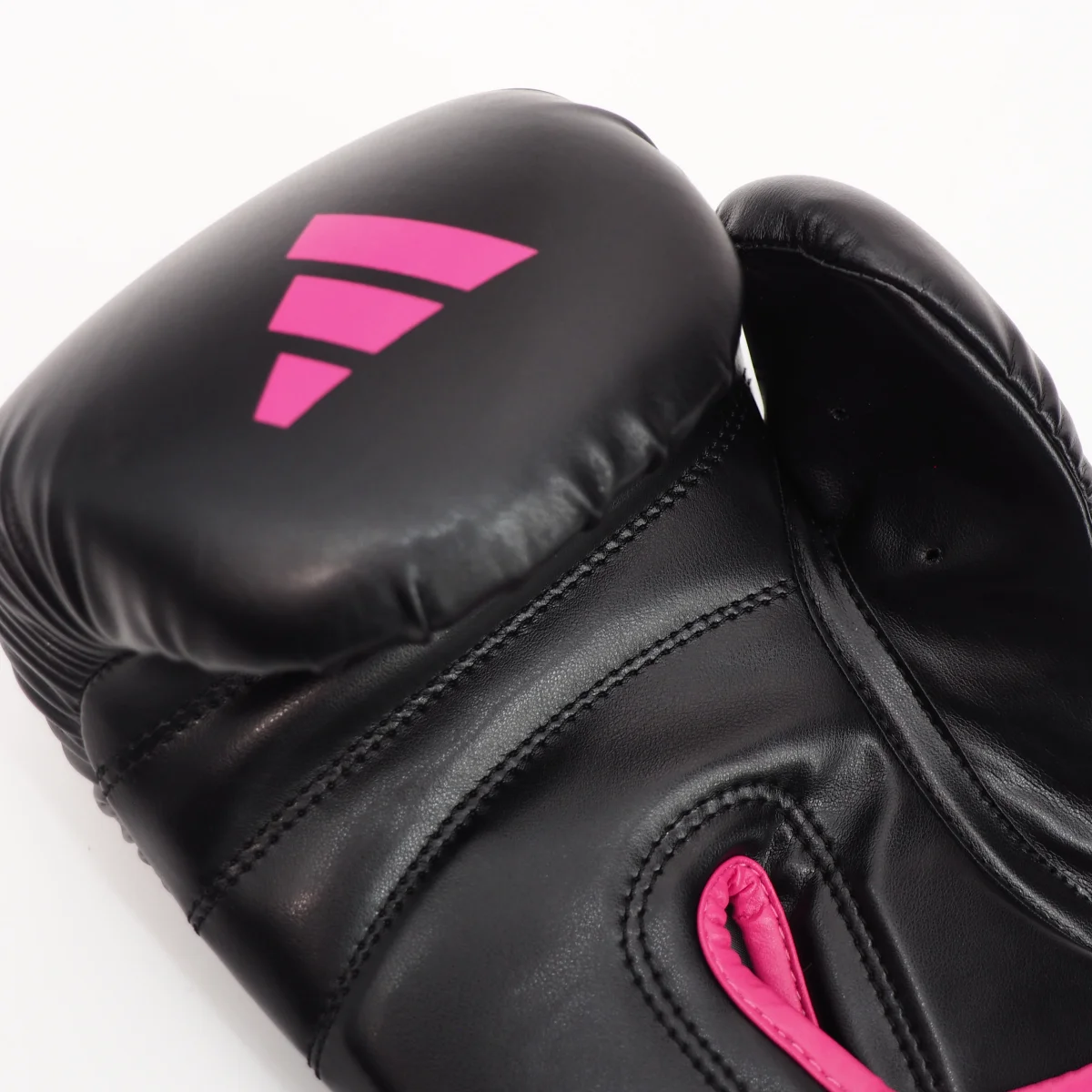 boxing glove, black glove, pink accent, synthetic leather, stitching detail